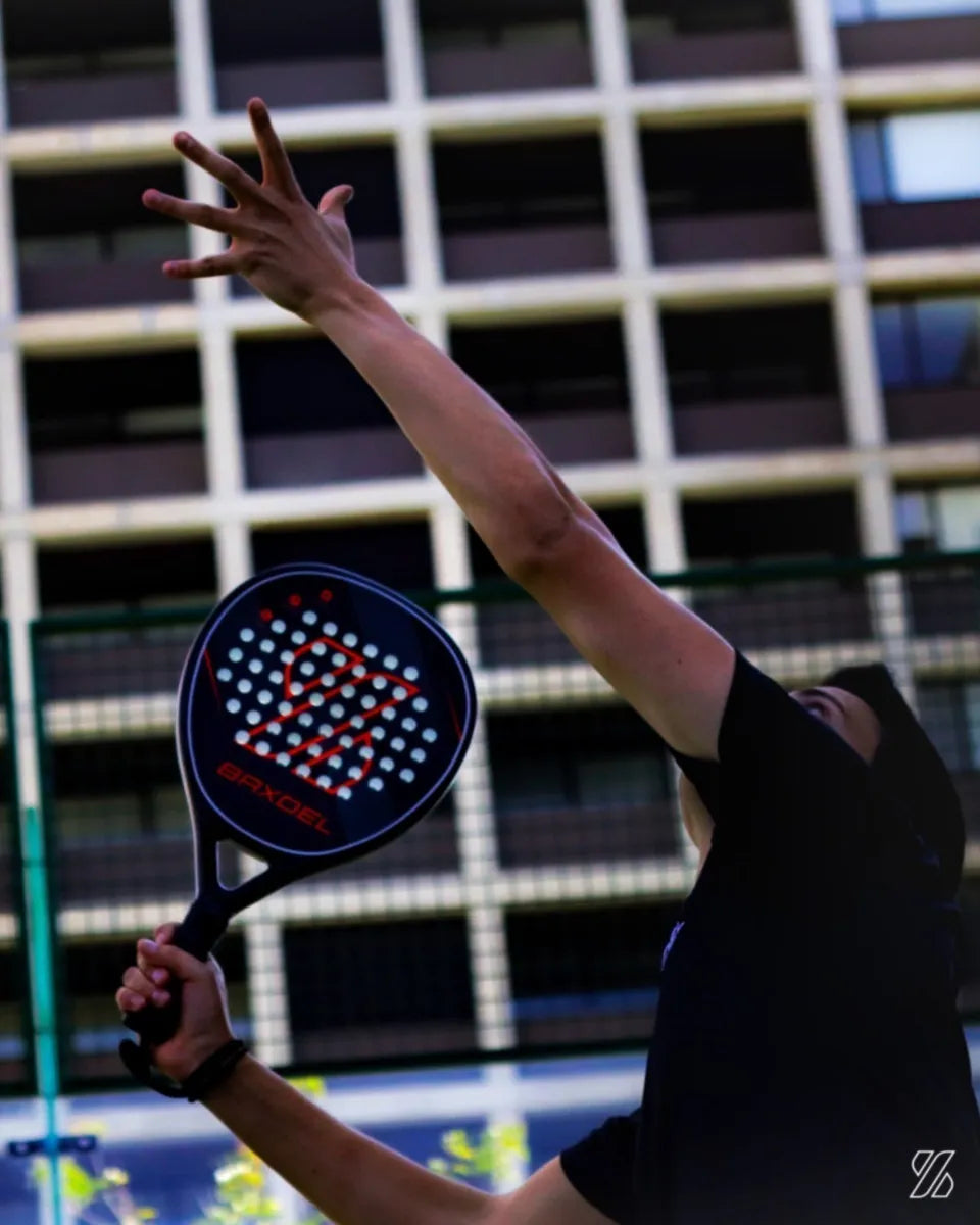 Jugador realizando volea con la pala de pádel Baxdel BX-1 Roja